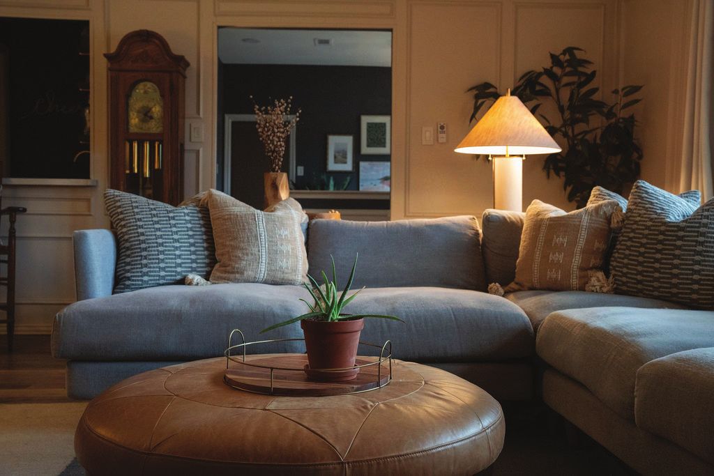 Family room with a blue sectional and leather ottoman